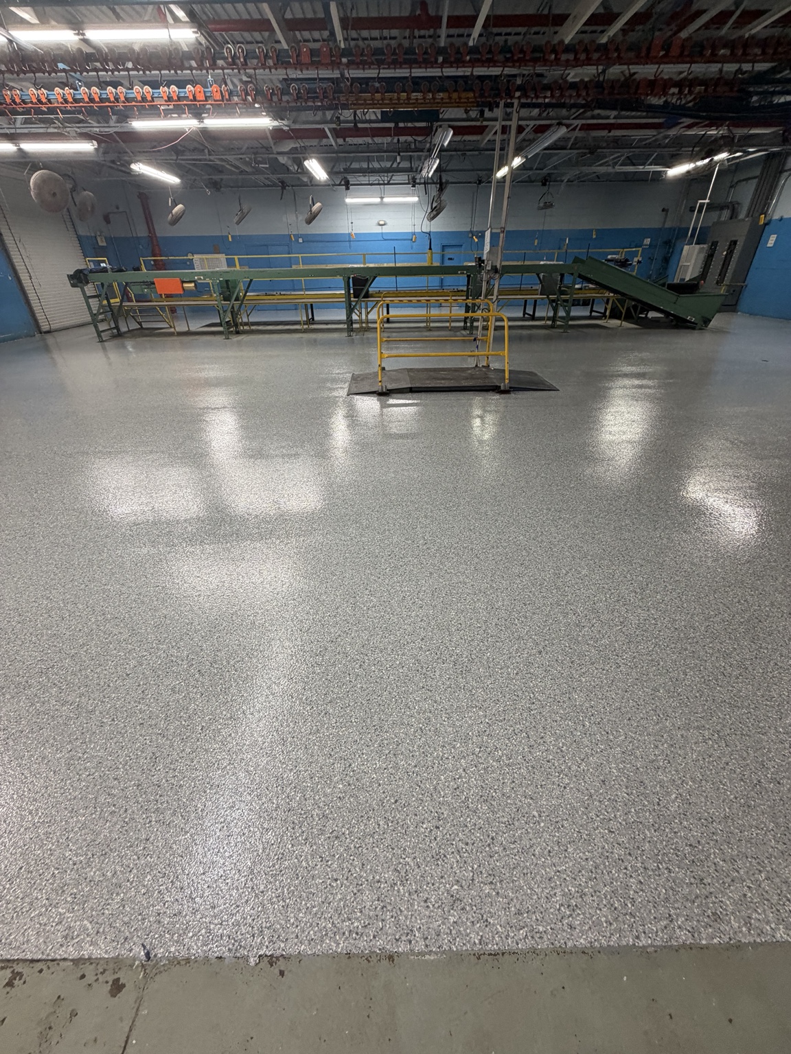 Wide view of a completed gray flake coating in a commercial work area