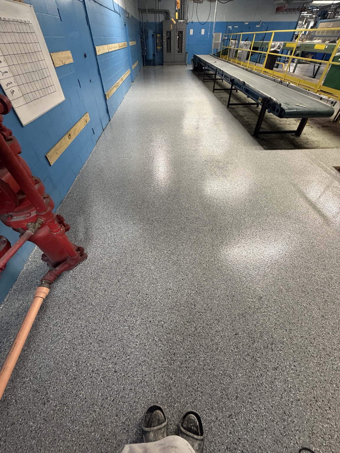 Coated walkway alongside equipment in an industrial facility