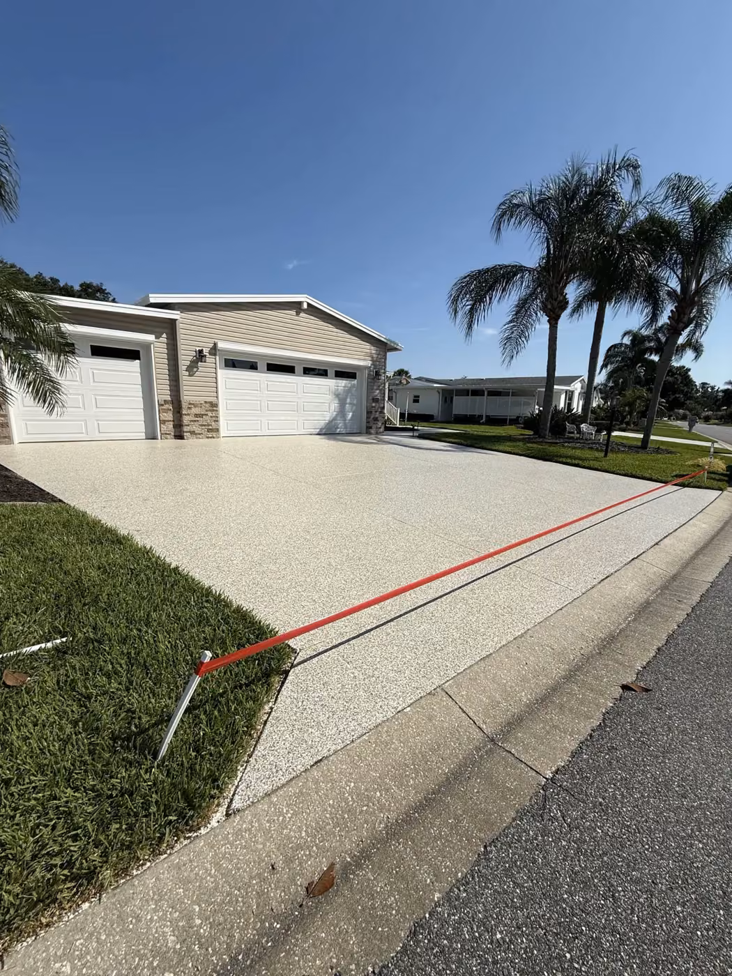 Decorative driveway coating installed by PolyCoat Solutions