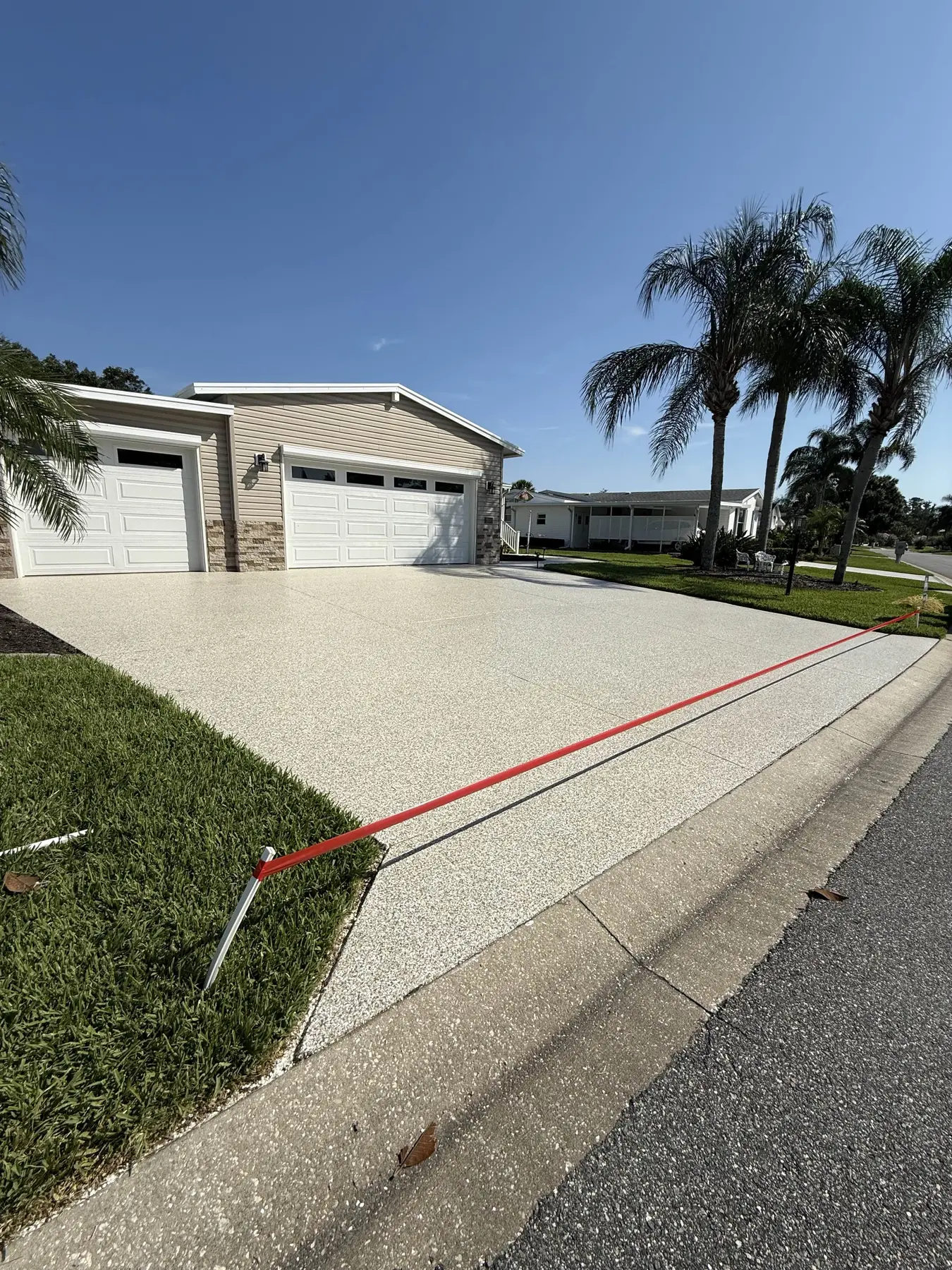 Decorative driveway coating installed by PolyCoat Solutions
