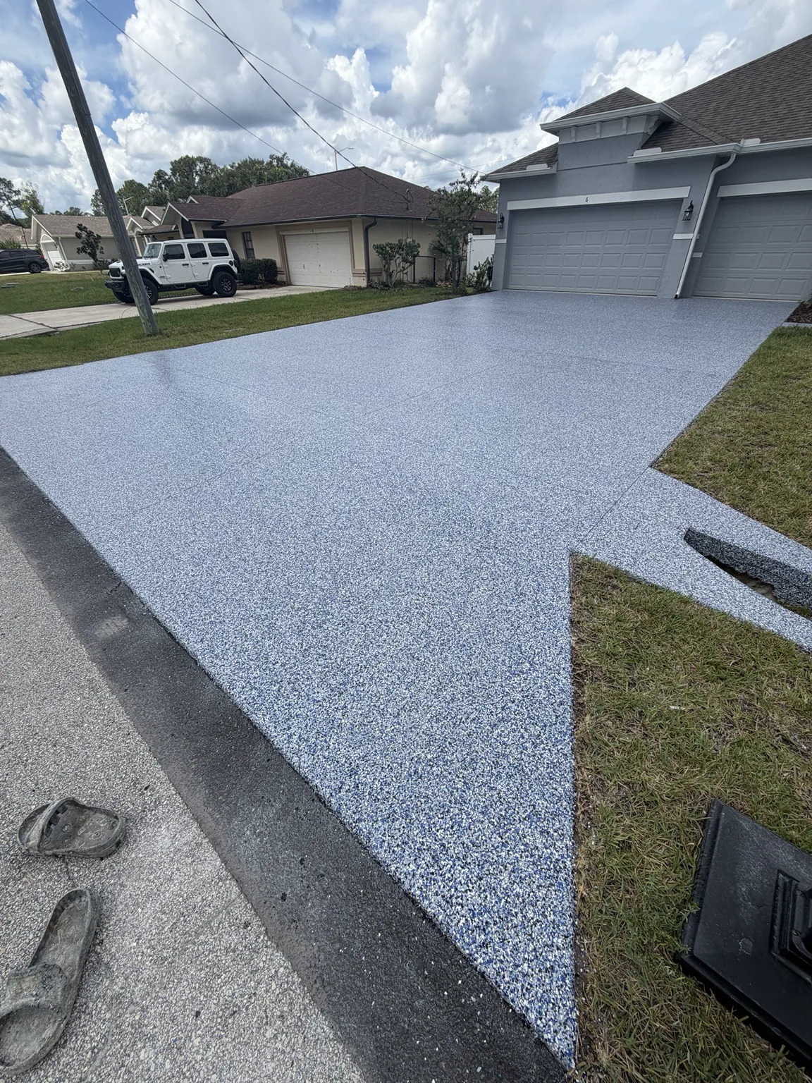 Gray decorative driveway coating with a full flake finish