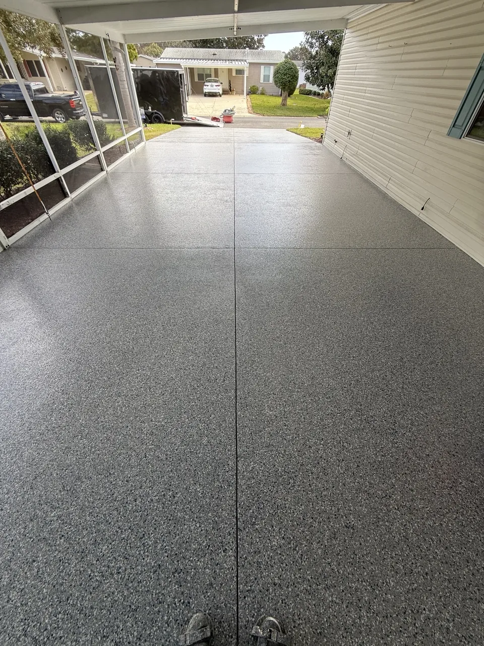 Gray decorative coating across a covered driveway