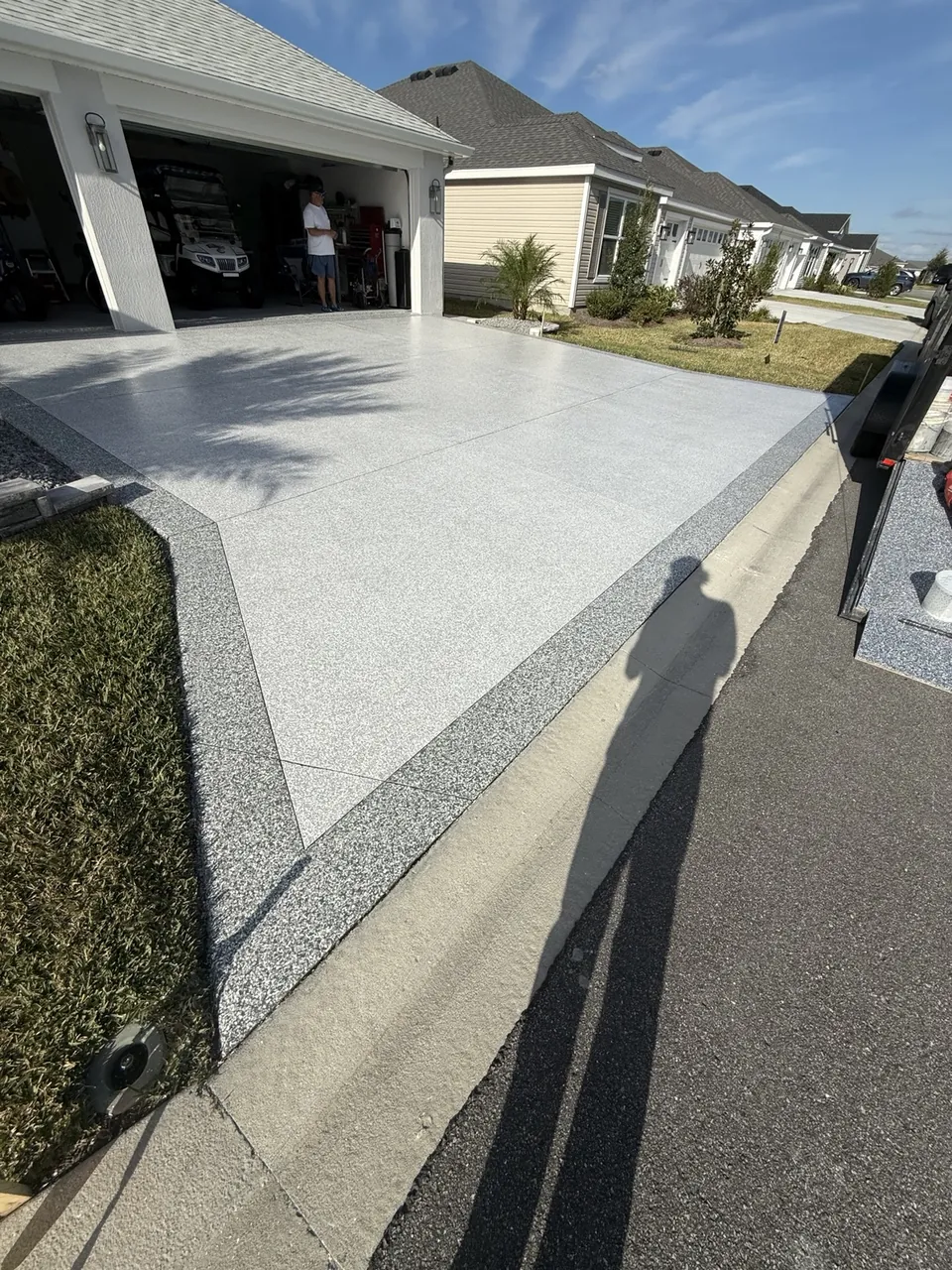 Light gray decorative driveway and garage entrance