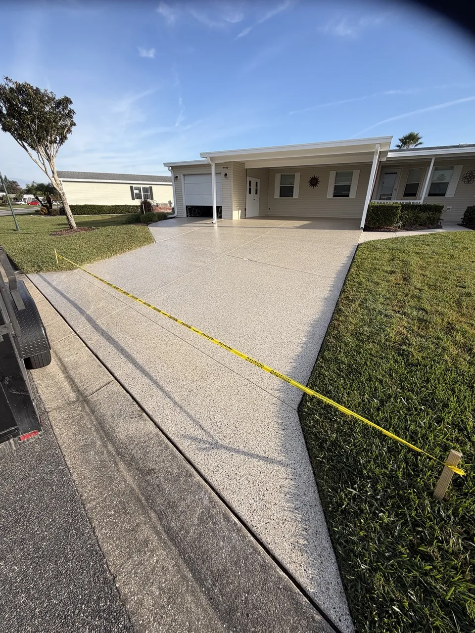 Tan decorative driveway coating at a single story home