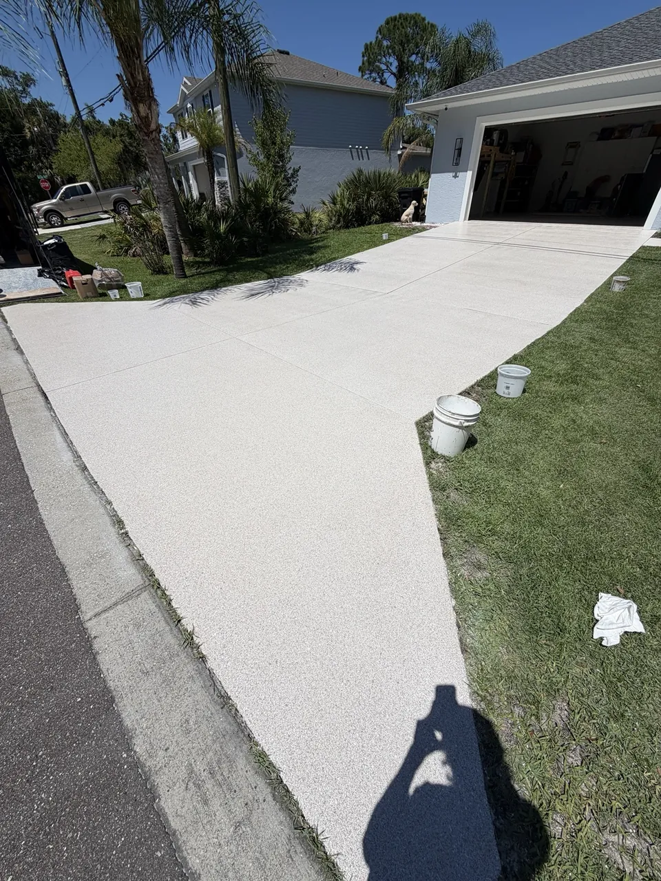 Bright coated driveway leading to an open garage
