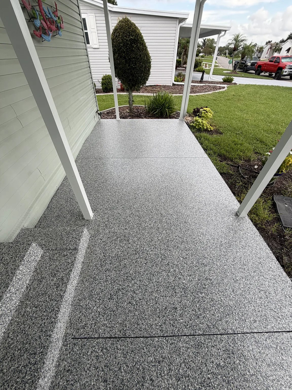 Decorative exterior walkway coating with a slip resistant texture