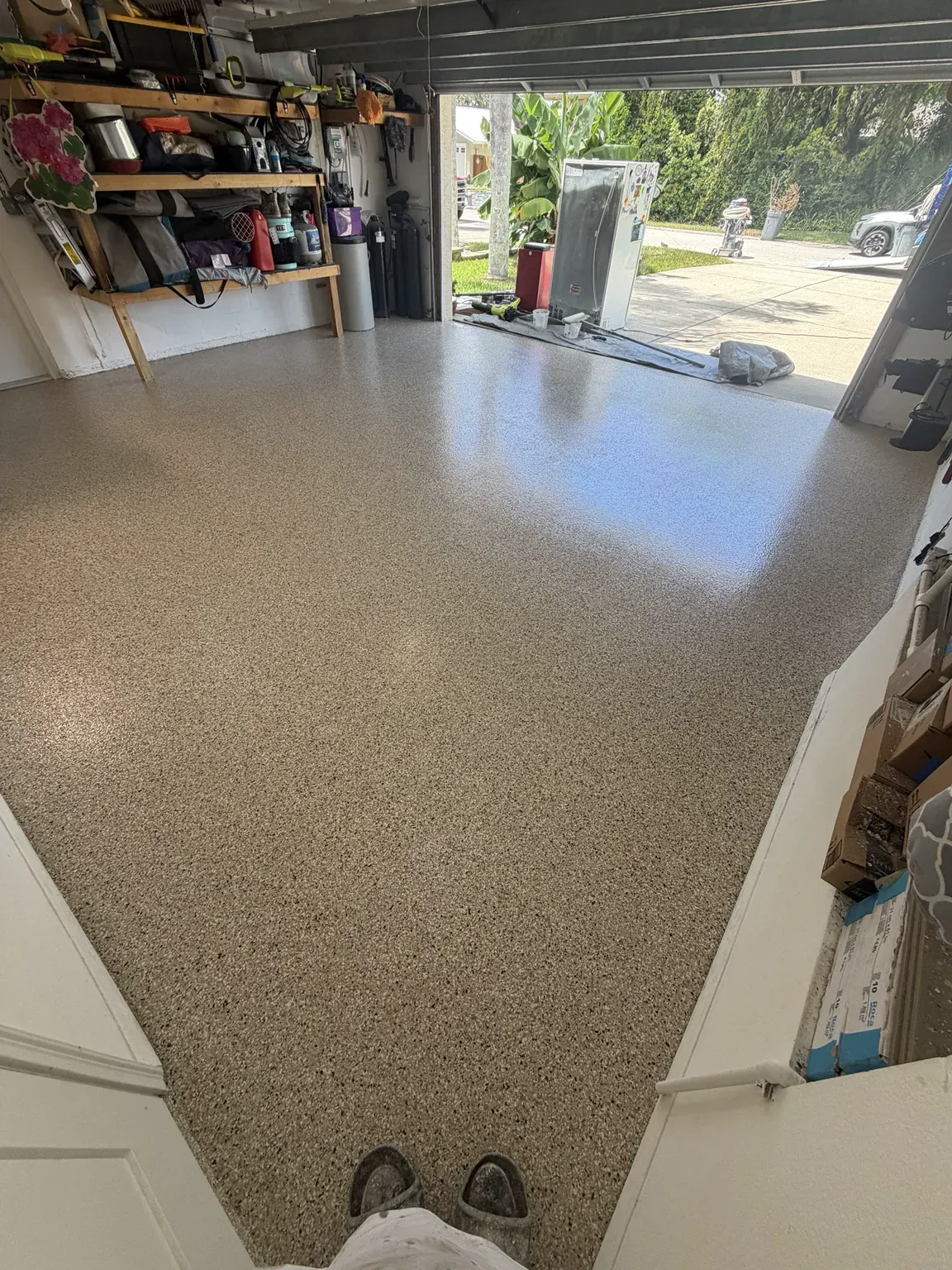 Decorative tan flake garage floor installed by PolyCoat Solutions