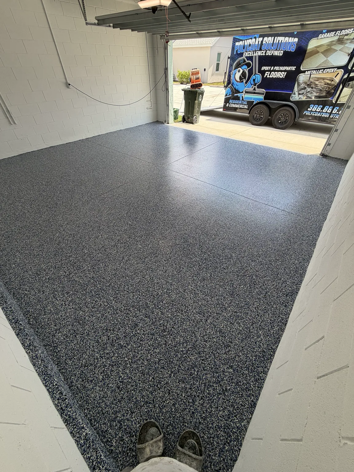 Freshly coated garage floor with a full decorative flake broadcast