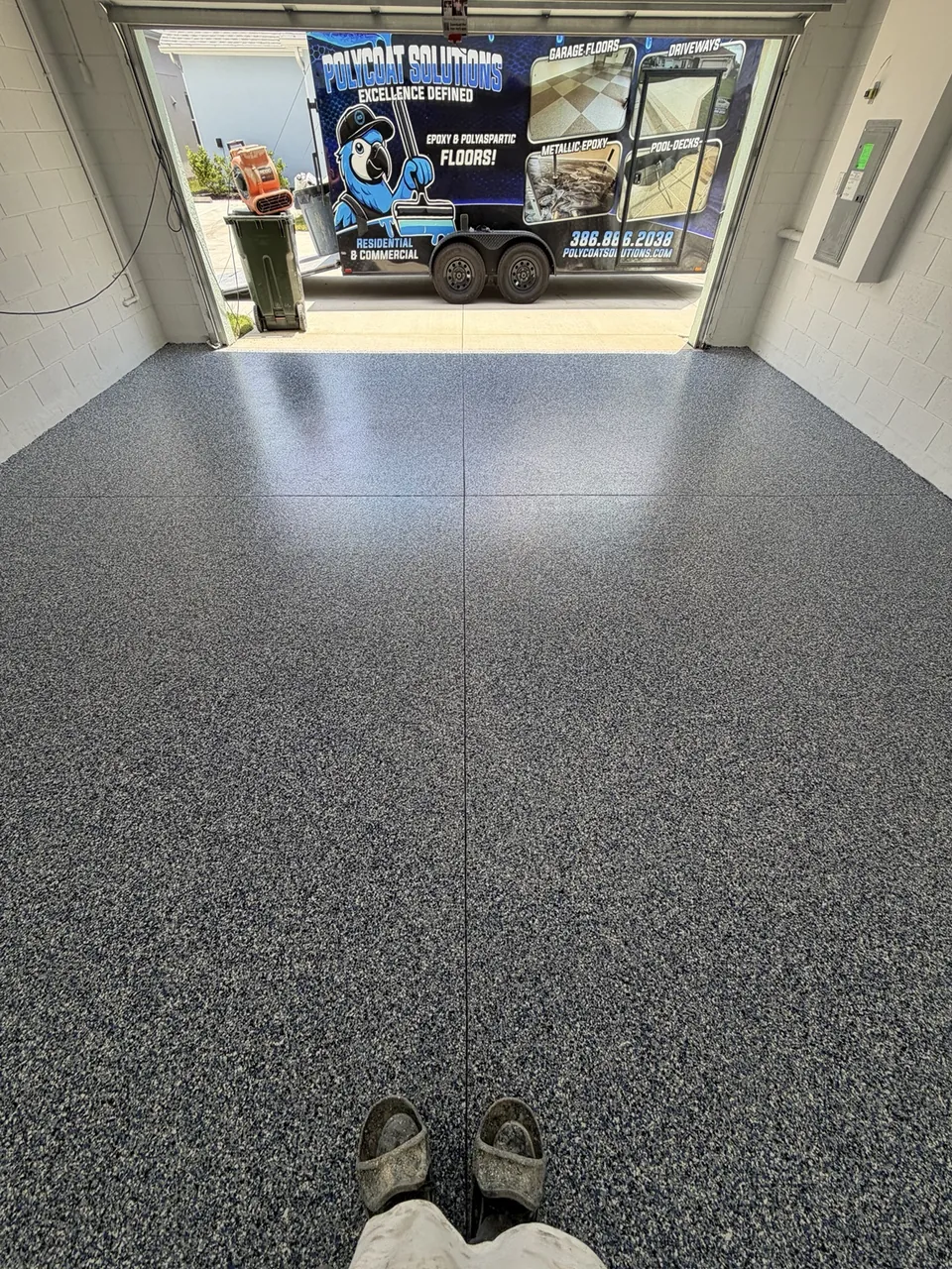Finished gray garage coating with the PolyCoat trailer outside