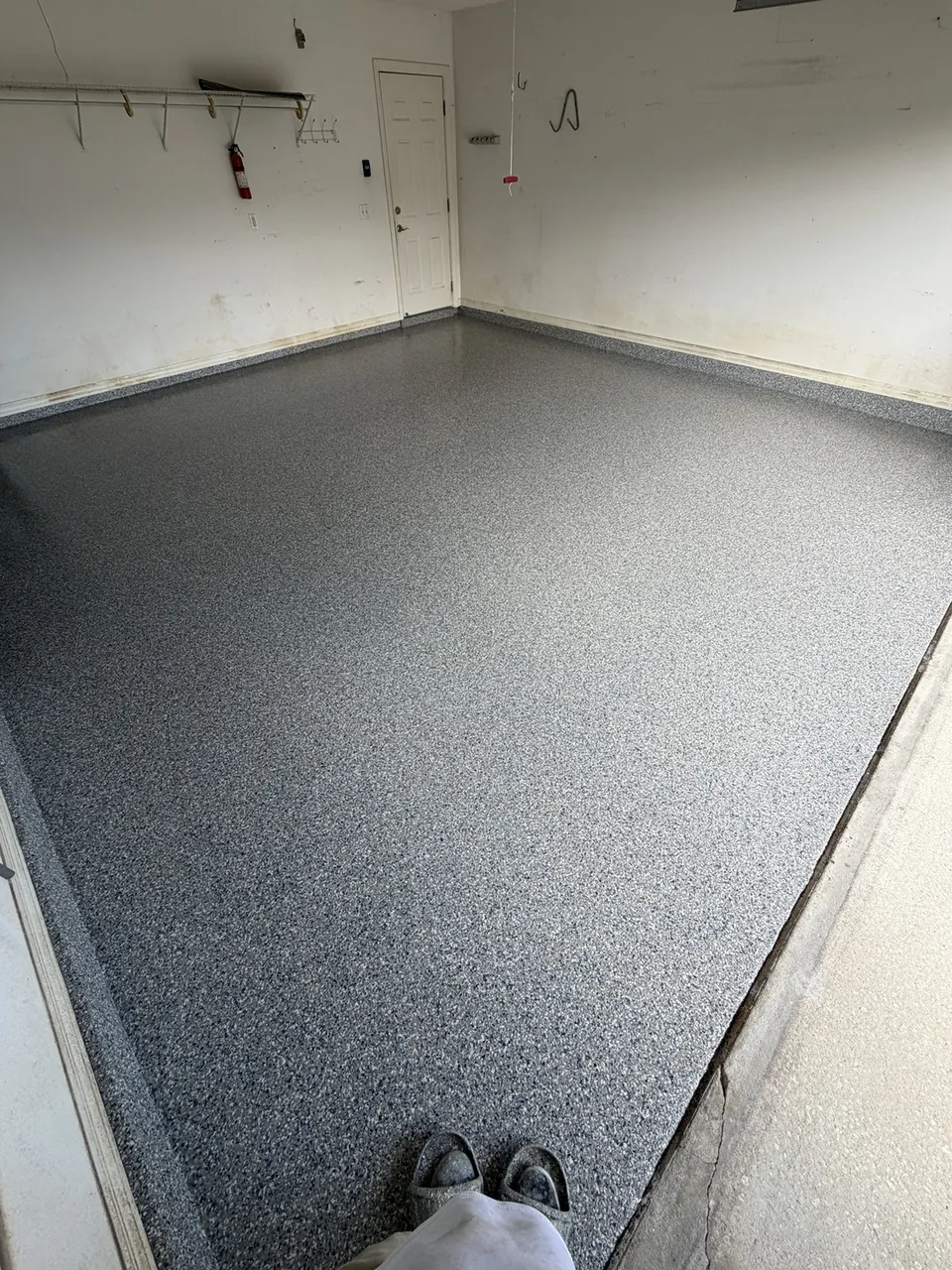 New gray flake garage floor with clean wall edges