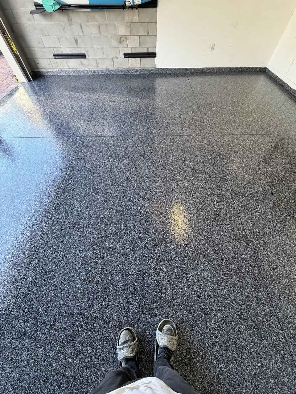 Close view of a finished dark flake garage floor coating