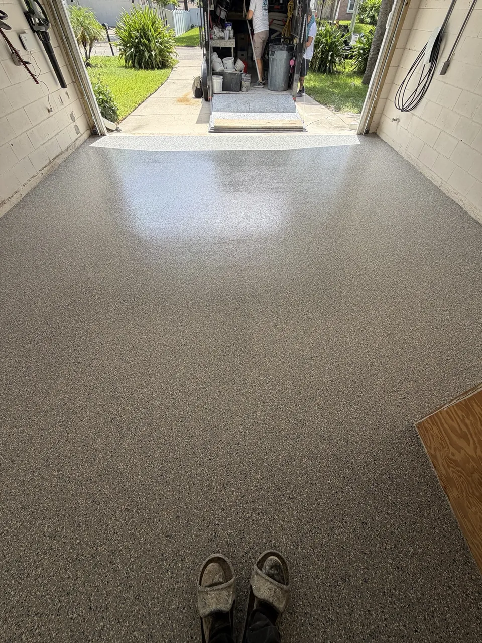 Light tan coated garage floor viewed toward the open garage door