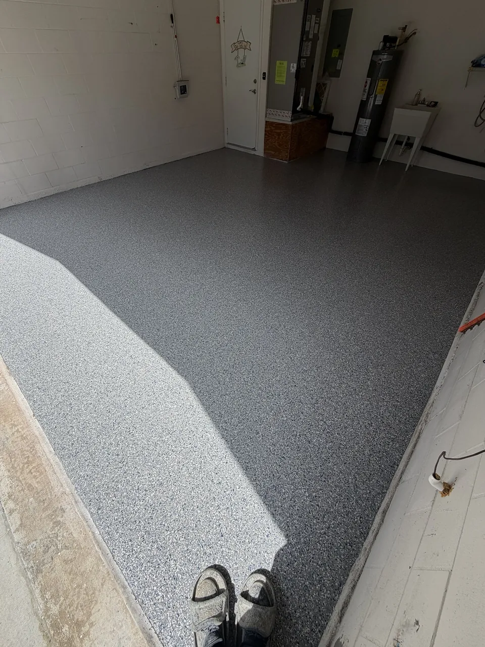 Gray decorative coating across a finished residential garage floor