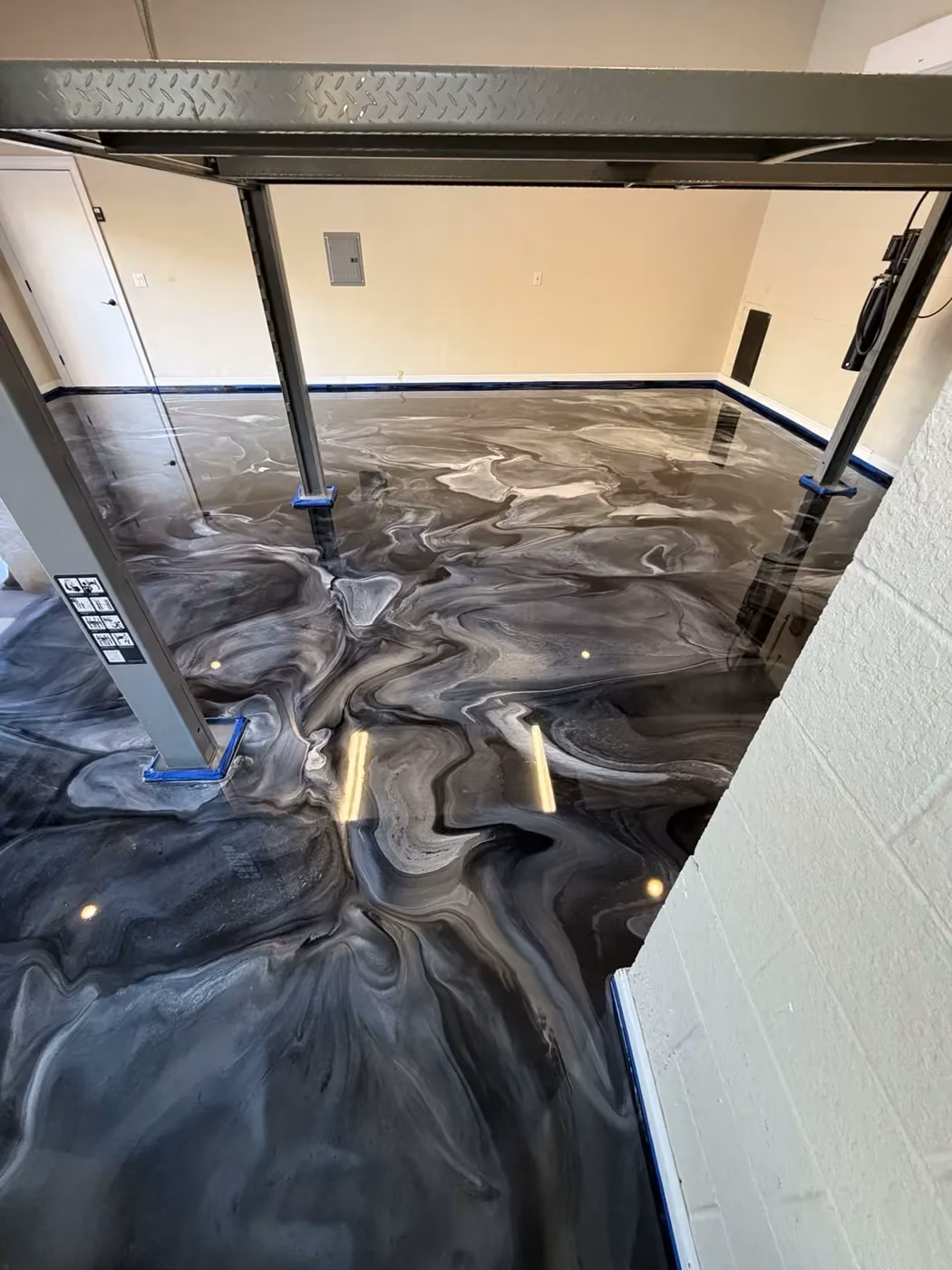 Black and white custom metallic epoxy floor by PolyCoat Solutions