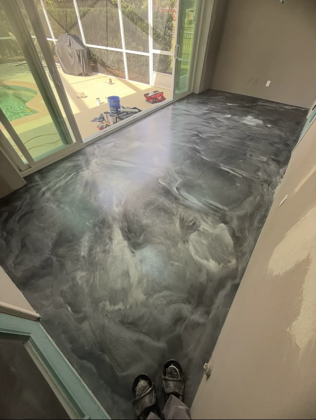 Gray and white metallic epoxy floor installed in a Central Florida home