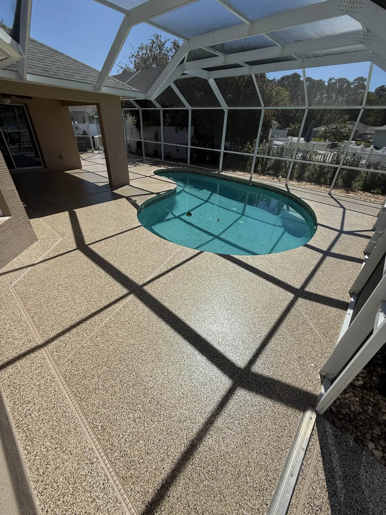 Resurfaced pool deck with a decorative coating system