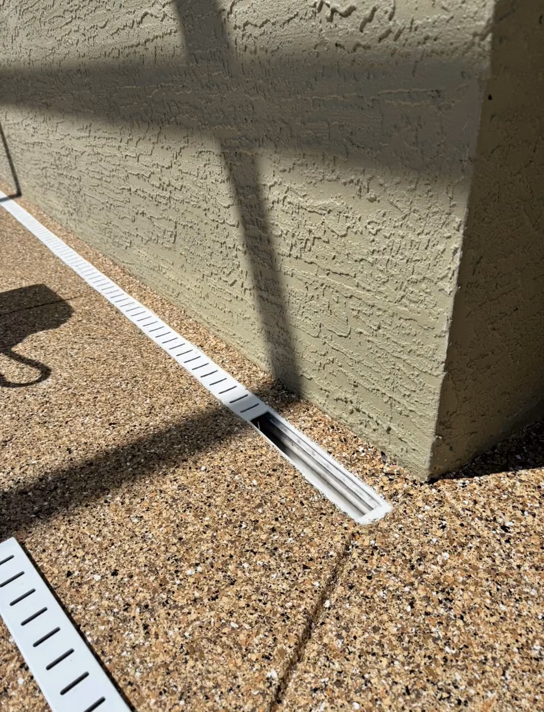 Open Drain Janitor access point for removing debris from a pool deck drain