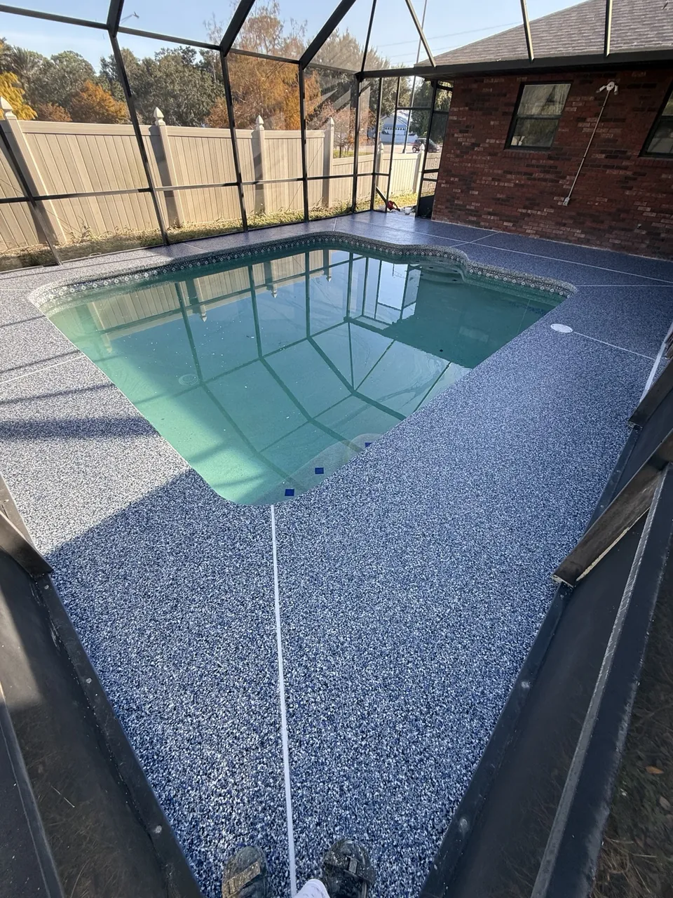 Blue gray decorative coating beside an enclosed pool